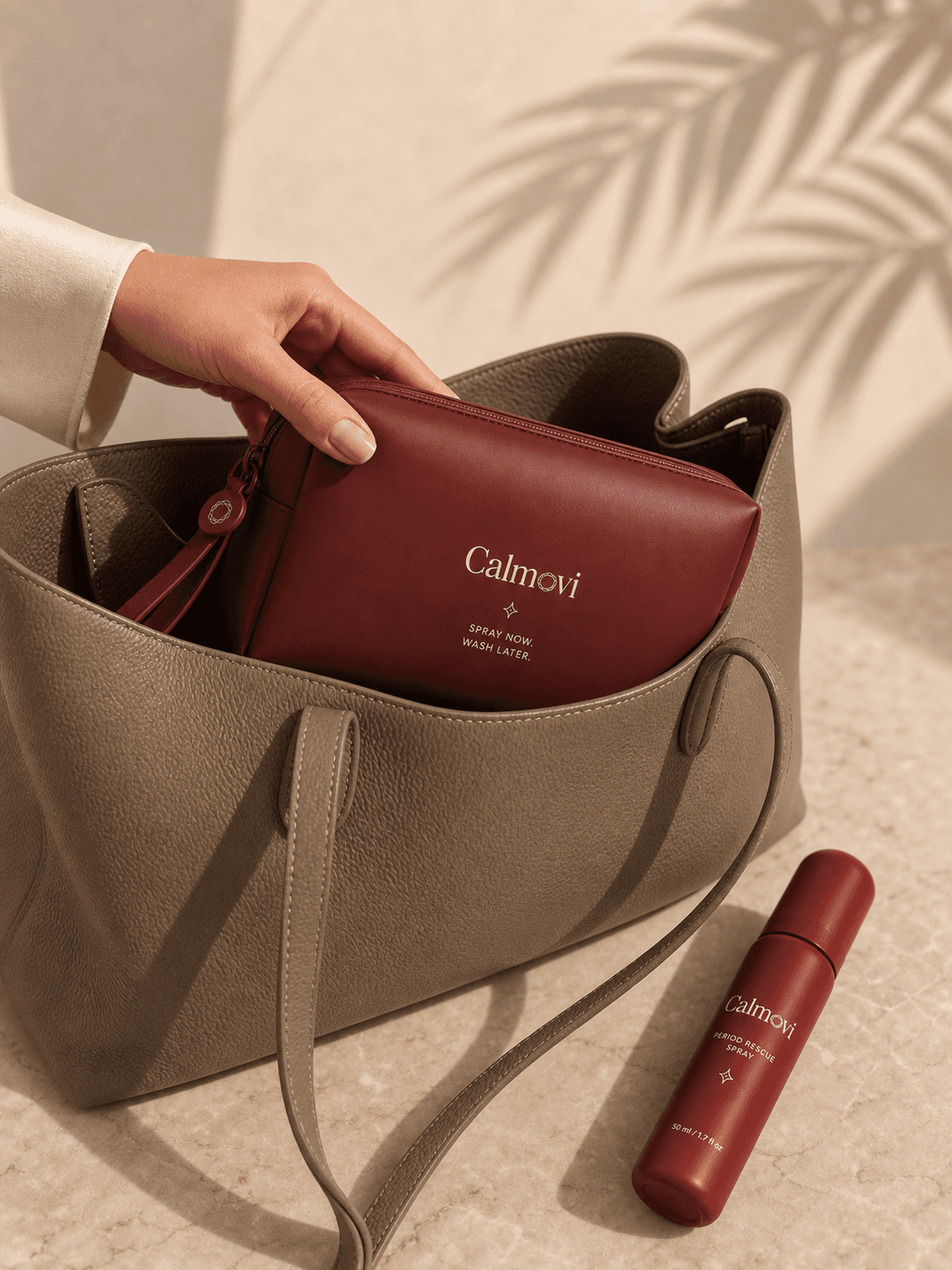 Calmovi waterproof period pouch being placed inside a handbag